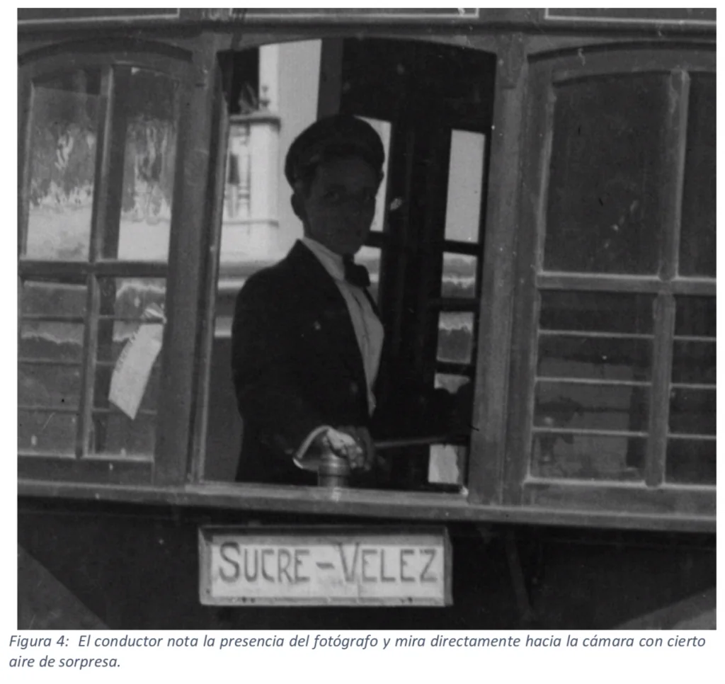 Close-up of the tram driver looking at the camera, with the Sucre-Vélez route sign